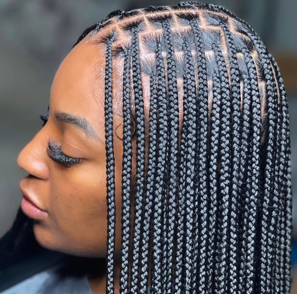 A woman with beautifully styled long braids